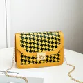 Yellow and black houndstooth pattern crossbody bag with gold chain strap and lock - Yellow