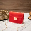 Red faux lizard skin crossbody bag with elegant gold chain strap and secure metal lock - Red
