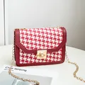 Red and white houndstooth patterned crossbody bag with gold-tone lock and chain strap - Red