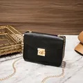 Elegant black lizard pattern square crossbody bag featuring a gold chain strap and lock - Black