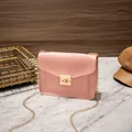 Elegant pink crocodile textured small square crossbody bag featuring a gold chain strap - Pink