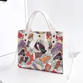 Fashionable white handbag with colorful sneaker print and decorative bow detail - Sneaker Print With Bow / White