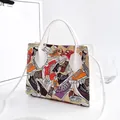 Stylish white handbag featuring a vibrant sneaker print and detachable shoulder strap - Sneaker Print / White