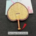 Traditional heart-shaped hand-woven straw fan featuring a dark red patterned border and tassel - Heart-shaped (dark red with red edges)