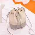 Elegant two-tone quilted drawstring bucket bag featuring cream and grey color block design - Drawstring Bucket / Light Gray