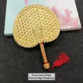 Traditional heart-shaped handmade woven natural straw hand fan with a vibrant red tassel - Heart-shaped (natural edge binding)