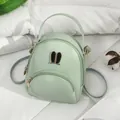 Mini mint green backpack for women featuring cute rabbit ear hardware and versatile straps - Green