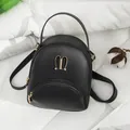 Chic black mini PU leather backpack for women featuring stylish golden bunny ear hardware - Black