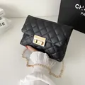 Elegant black quilted cross-body chain bag with a metallic gold lock clasp closure - Black