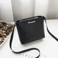 Elegant black textured leather crossbody square bag for women with gold script logo - Black