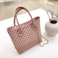 Elegant pink crossbody handbag with vintage floral print and decorative gold chain strap. - Pink