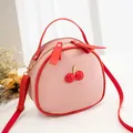 Cute pink cherry crossbody bag with red lychee texture trim and adjustable strap - Pink