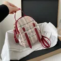 Small plaid backpack with red straps and gold zipper details - Red
