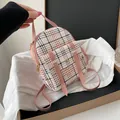 Stylish small pink plaid backpack for women with an adjustable crossbody strap - Pink