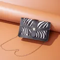 Small zebra print square crossbody bag for women with elegant gold chain strap. - Zebra Print