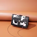 Small stylish cow print crossbody bag with gold chain strap and metal button closure - Cow Print