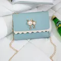 Elegant teal small square crossbody bag with cat pearl charm and gold chain strap - Blue (Leather)