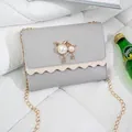 Elegant gray small square shoulder bag with cat-shaped pearl accents and gold chain - Gray (Leather)