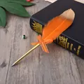 Detailed view of an elegant orange feather ballpoint pen with a gold barrel and bow - Orange Feather