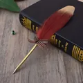 Elegant burgundy feather ballpoint pen with a striped bow detail resting on a vintage book - Wine Red Feather