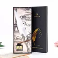 Close-up of elegant white feather dip pen set with ornate silver holder in gift box - 1 Pen + 1 Ink + 5 Nibs / White