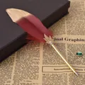 Detailed view of a vintage quill ballpoint pen with red and gold feather decoration - 枣红(8064) / 0.5mm