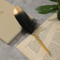 Detalle de bolígrafo de pluma con punta dorada y plumaje negro sobre papel de estilo vintage - Estilo Pluma Negro Dorado (0027) / Punta de Bala de 0.7 mm / Negro