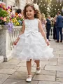 Detailed view of an elegant white ruffled flower girl dress with a large bow and floral bodice - Dresses / 10-11 Years