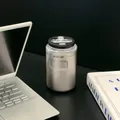 Silver stainless steel insulated coffee cup on a black desk with laptop and book - 350ml / Natural