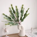 Detail view of artificial cactus plant in creative white fist vase for home decor - White