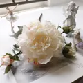 Vista detallada de una peonía artificial blanco crema con texturas de pétalos realistas. - Blanco Champaña