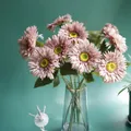 Detailed macro shot of realistic pink artificial Gerbera flowers in a stylish glass vase. - Flesh Pink