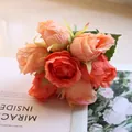 Close-up detail of a bouquet of realistic orange silk roses for wedding flower decoration - Watermelon Red Rose