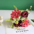 Close-up detail showing artificial red ranunculus, hydrangea and carnation bouquet - Red