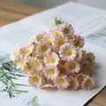 Close-up detail of realistic artificial pink and yellow small daisy flower bouquet for home decor - Pink