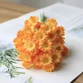 Close-up macro view of realistic orange artificial daisy bouquet for home decoration - Orange