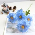 Close-up detail of blue artificial 5-headed chrysanthemum flowers for home decor. - Blue