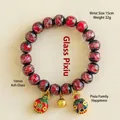 Bracelet traditionnel en perles de verre rouge 10mm avec breloque bête gloutonne dorée - Famille de Bête Tunjin Rouge / 10mm