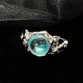 Close-up of lava texture silver ring with iridescent blue-green moonstone - Adjustable Open Size / Style 2 (ALk5JxmTKa5)