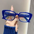 Handheld close-up of stylish retro blue rectangular frames for anti-blue light reading - +1.00 Degree / Blue Frame
