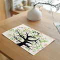 Detail of linen placemat featuring a vibrant green tree design with birds on wooden table - 舒展黑色大树款式(7823-9) / 32*45cm