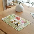Detailed view of a linen placemat featuring a charming spring meadow and cat illustration. - 7848-11(水彩小猫红花绿植款) / 32*45cm