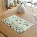 Macro view of a linen placemat featuring a rustic country house and bird illustration - 7848-6(乡村小屋猫咪款) / 32*45cm