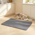 Premium grey quilted waterproof pet mat displayed in a cozy kitchen scene with a cat - Size S (50x35cm) / Gray