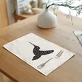 Detailed view of a geometric hummingbird print linen placemat set on a wooden dining table - 32x45cm / Hummingbird Print (7003-9)