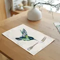 Detailed view of watercolor hummingbird linen placemat on a wooden dining table with fork - 32x45cm / Flying Hummingbird (7003-11)