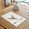 Watercolor hummingbird linen placemat elegantly displayed with a fork on a wooden table. - 32x45cm / Realistic Hummingbird (7003-13)