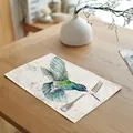 Detailed watercolor hummingbird linen placemat on a wooden dining table with a silver fork. - 32x45cm / Cyan Hummingbird (7003-15)