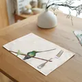 Watercolor hummingbird linen placemat on a wooden table with a metal fork detail - 32x45cm / Colorful Gradient Hummingbird (7003-21)