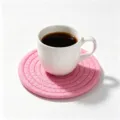 Premium handmade pink woven cotton rope coaster for coffee cups on a minimalist white background - Diameter 11cm / Pink